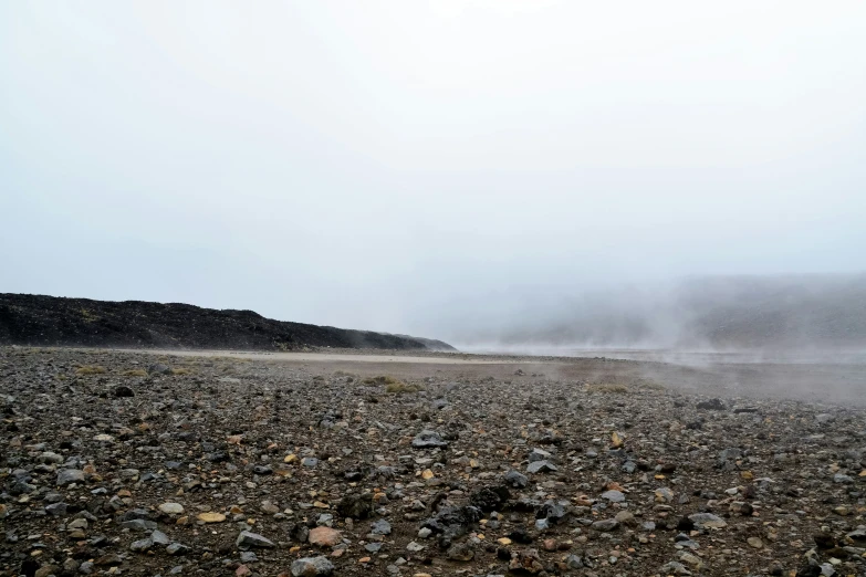 steam rising from a dry, sandy area in the mountains