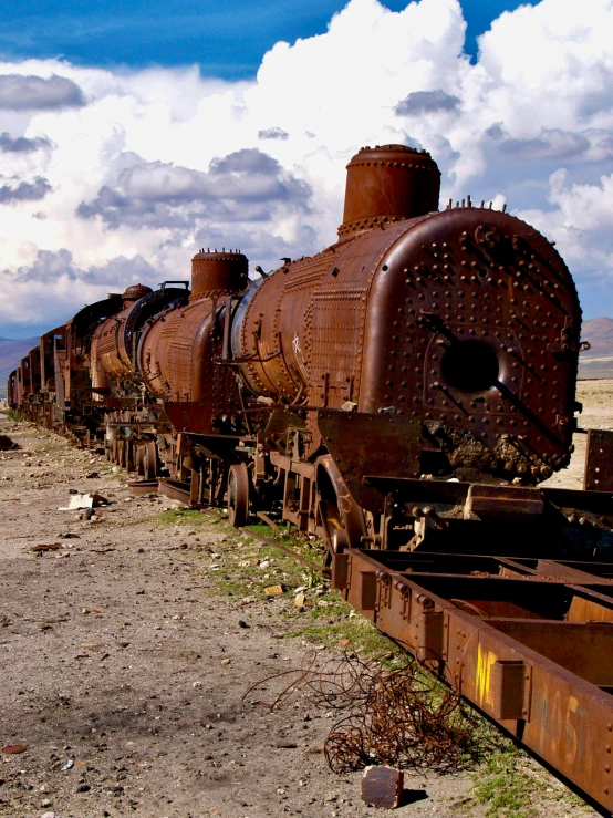 a row of train carts sitting on the tracks