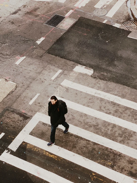 a man walks down the street while using his phone