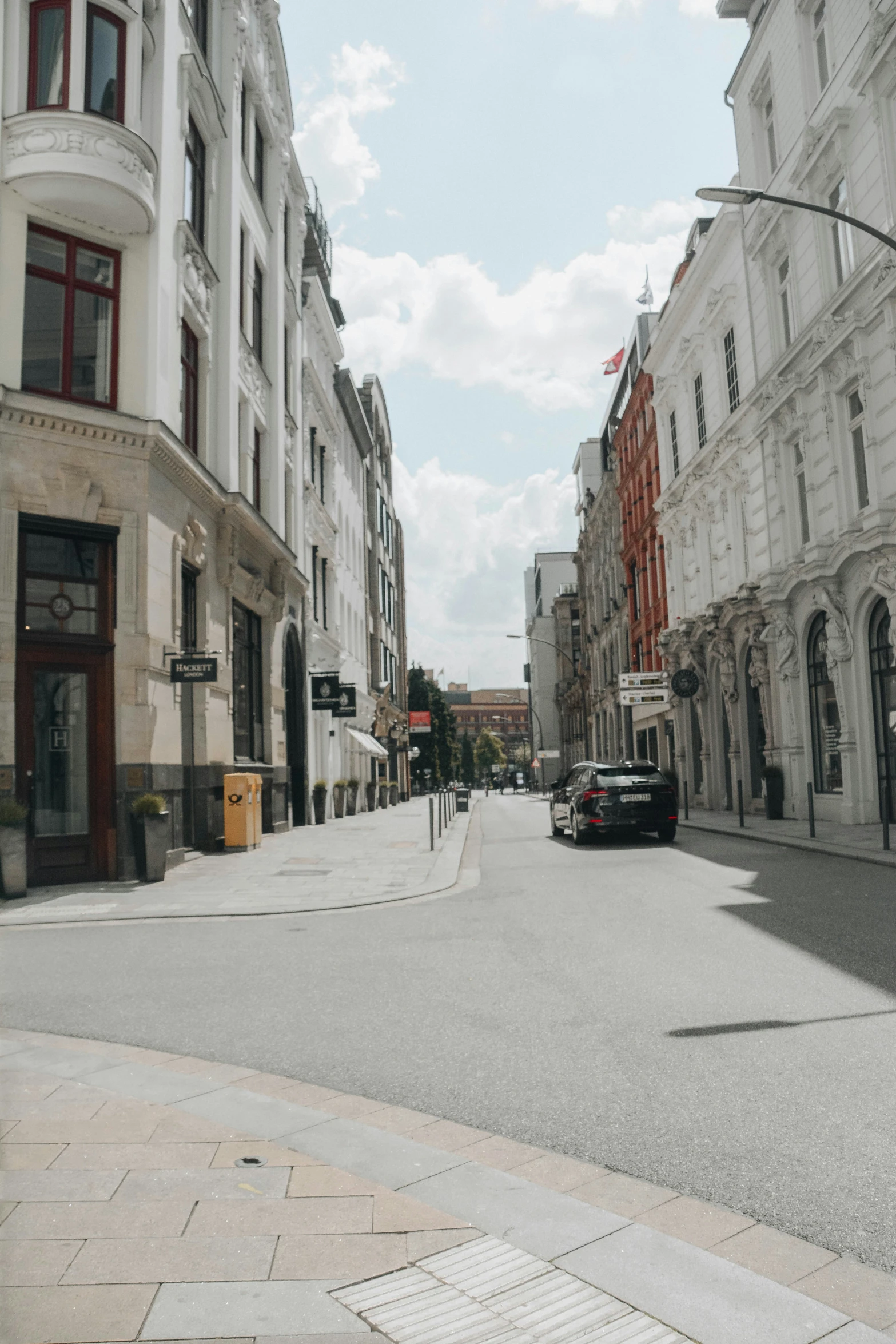 two cars driving through a deserted city street