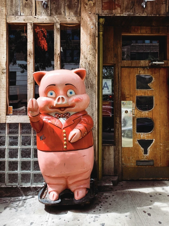 a pig statue with a baseball uniform on