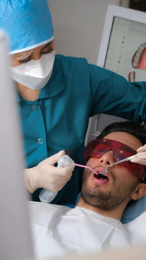a man is having  performed on his teeth