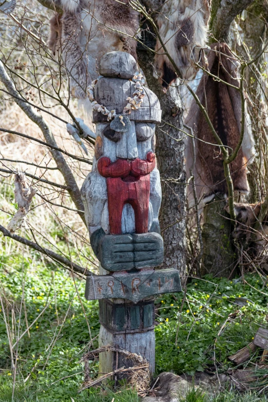 wooden carving of a man sitting on a wooden post