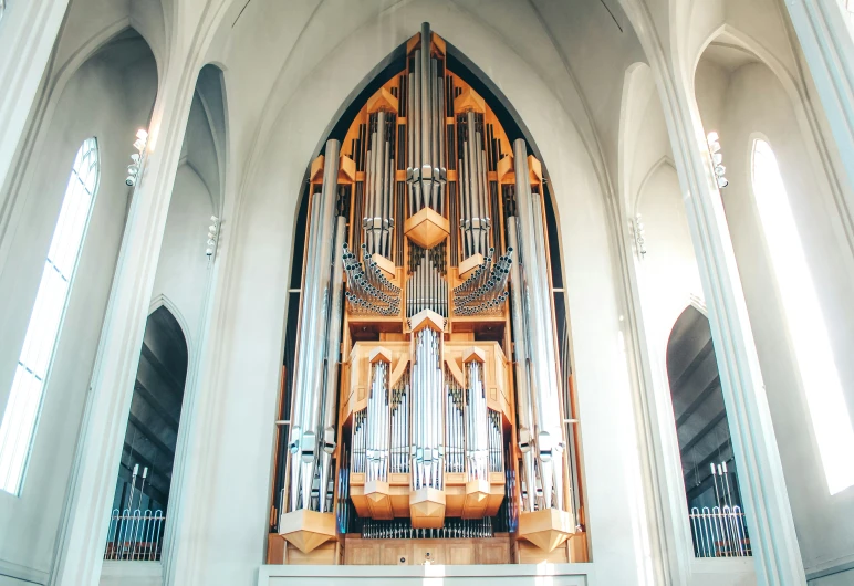 an organ in a cathedral with windows on the inside