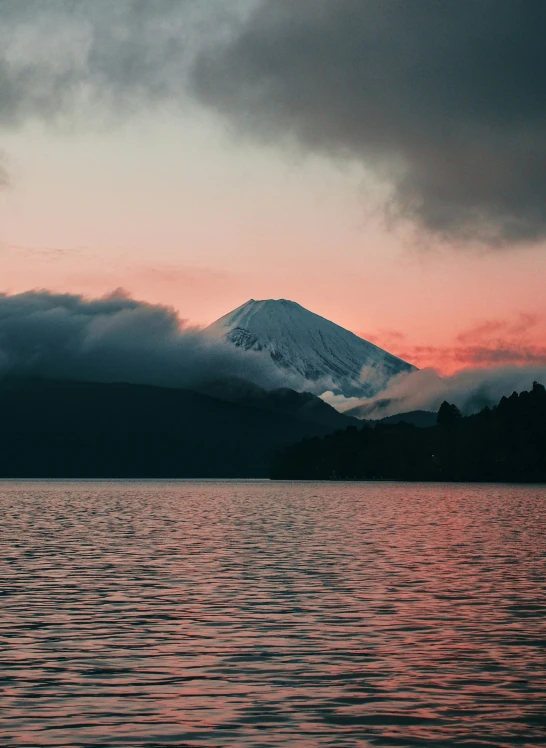 a beautiful sunset at a mountain surrounded by clouds