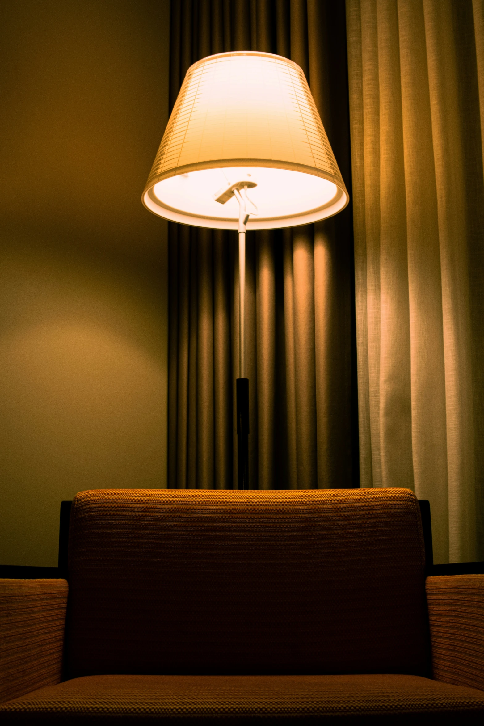 a light sitting on top of a table next to a lamp