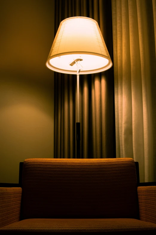 a light sitting on top of a table next to a lamp