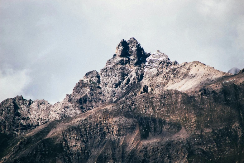 a snowy mountain top rises above the hills