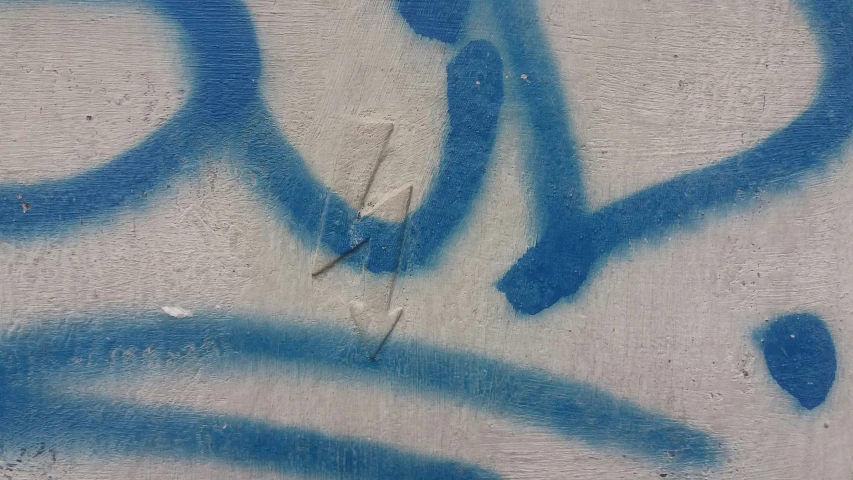 there is blue spray painted on the wall