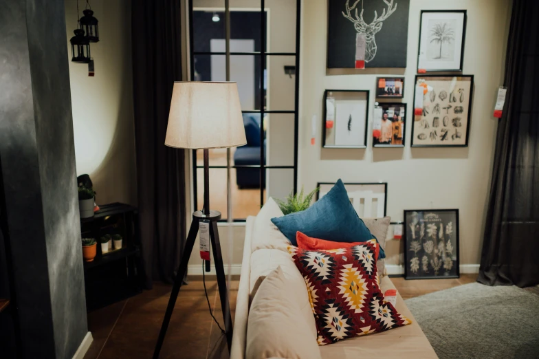 a living room with several different couches and a lamp