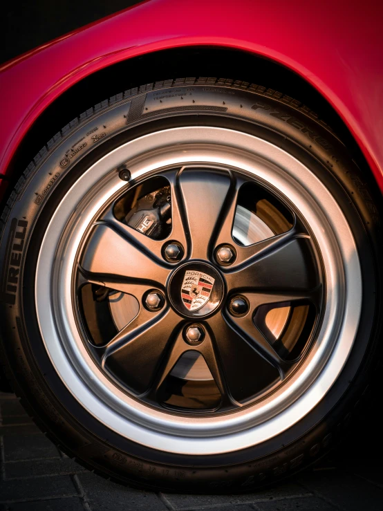 a close up view of a red car wheel
