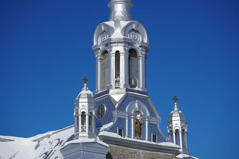 a tall steeple with snow on it