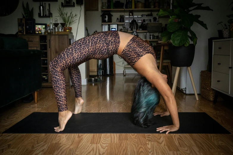 a woman doing yoga poses while standing on her hands