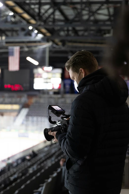 a person that is holding a camera and looking at soing