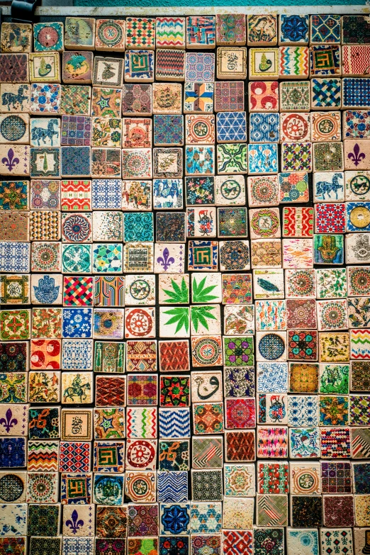 colorful tiled tiles on a wall next to a bench