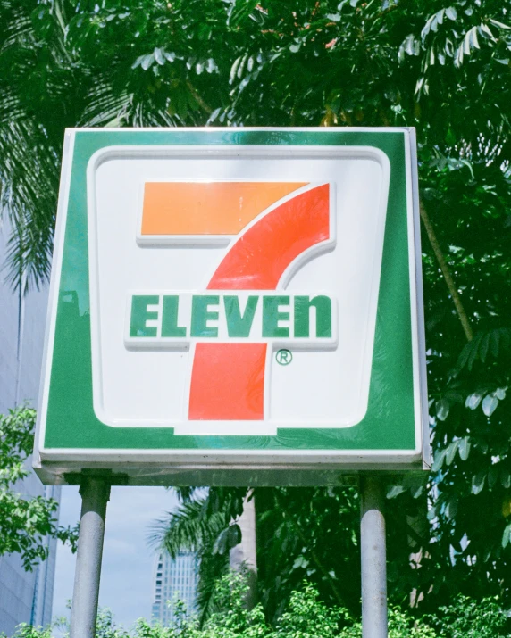 a green and white sign that says seven seven