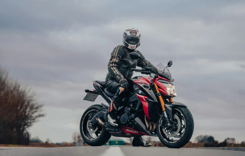 a man that is on top of a motorcycle