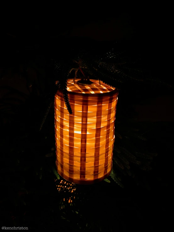 an orange lantern in the dark with light