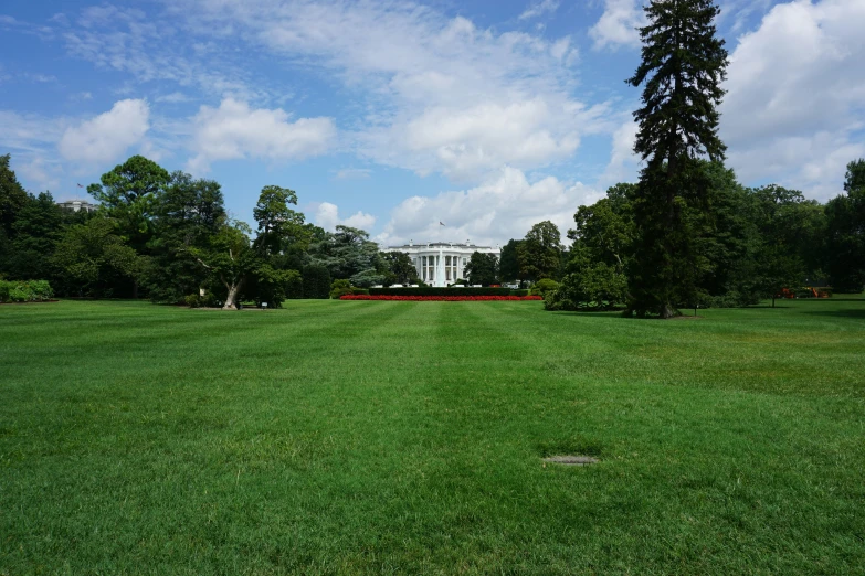 a white house with lots of grass around it