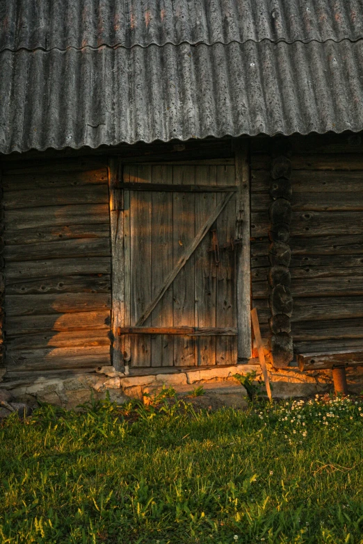 an old wooden barn with a large door