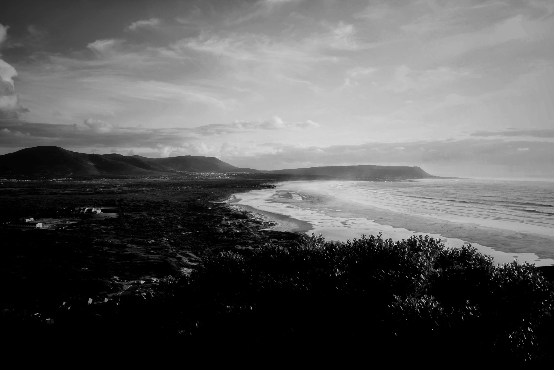 a person walking on top of a hill near the ocean