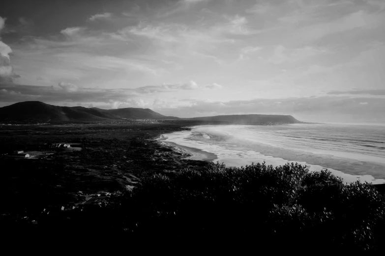 a person walking on top of a hill near the ocean