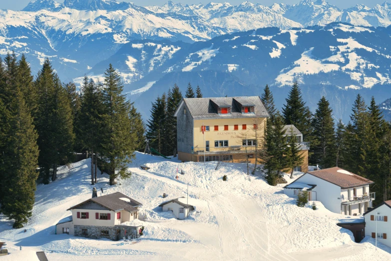 a building on a snowy hill covered in snow