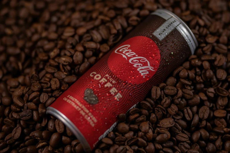 a red coffee can is over roasted brown coffee beans