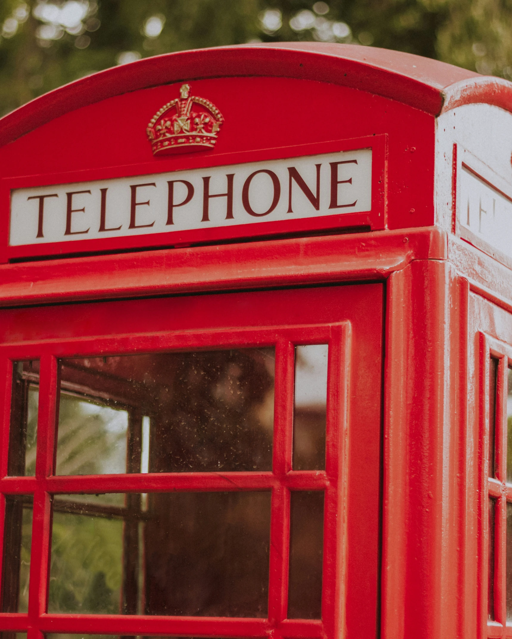 a red telephone booth with the word phone on it