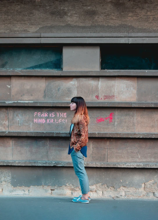 an image of a woman looking up while standing on a street