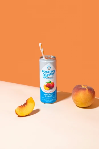 a can and fruit are on a white surface