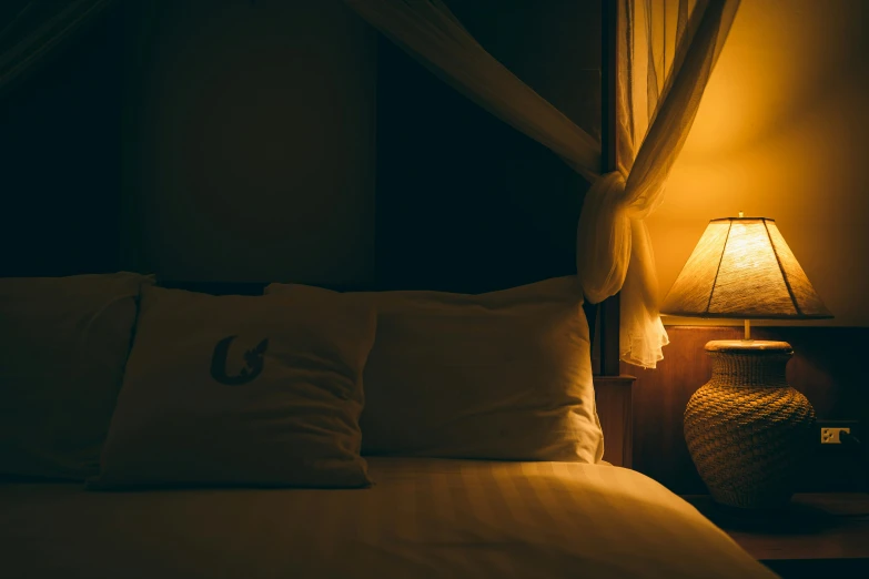 pillows and lamps are arranged on the bed