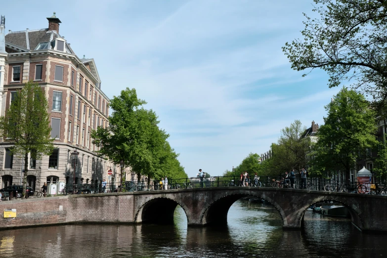 some very pretty buildings along a waterway with a bridge