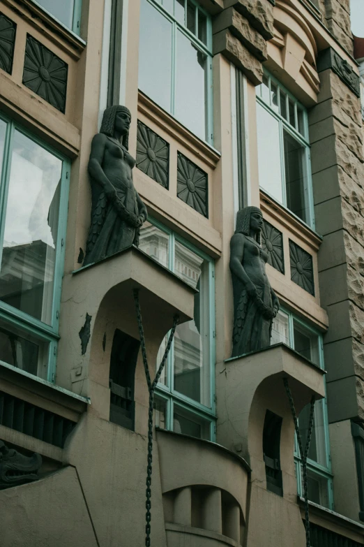 the statues on the building are looking upward