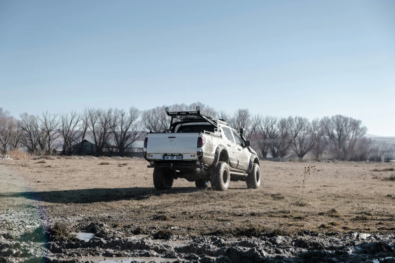 a truck on the side of a dirt road