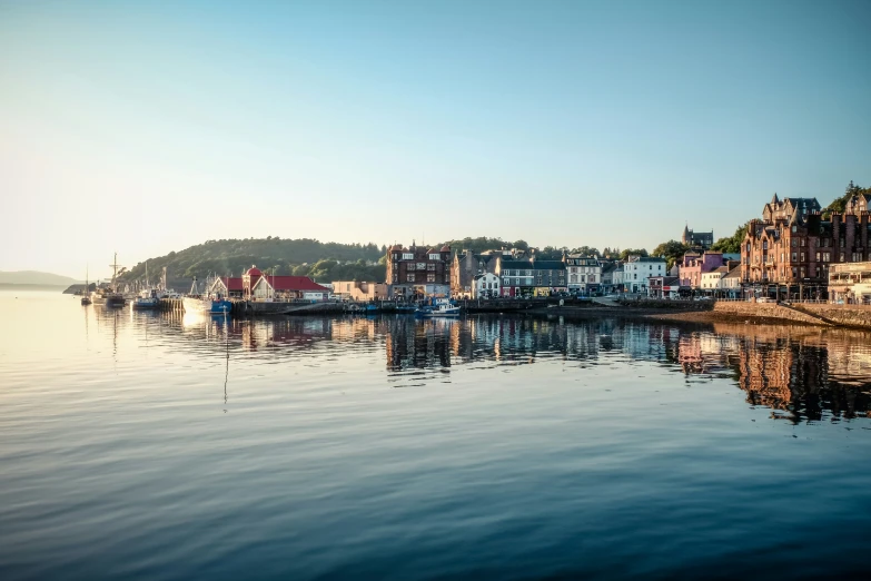 a small town is reflected in the water