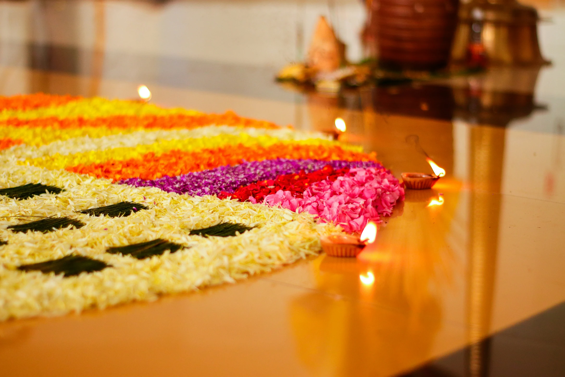 many small candles are lit in flower designs