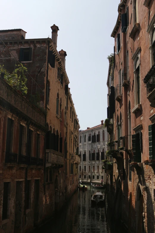 buildings line the water in a canal between two streets