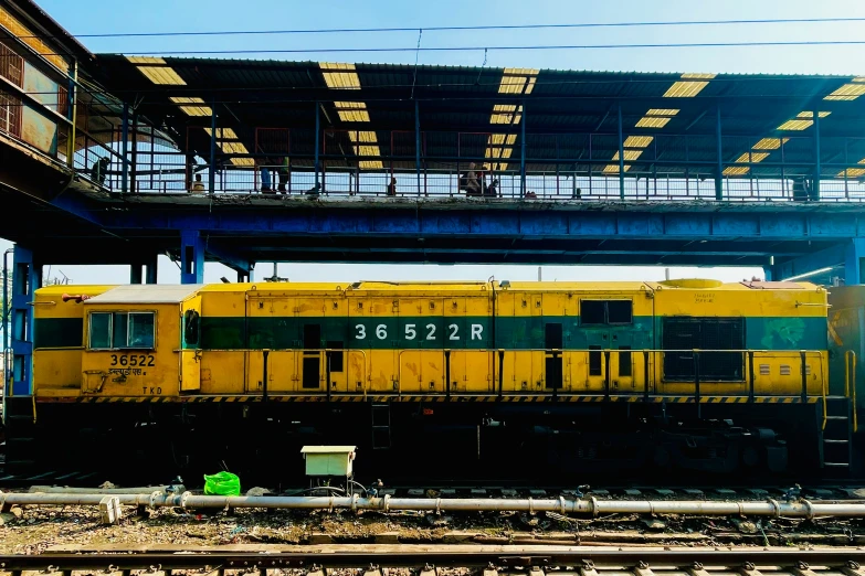 a yellow and black train sitting on a train track