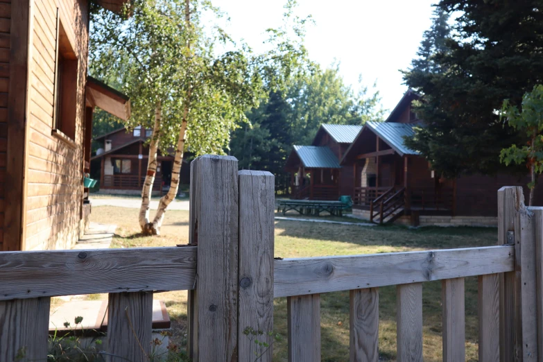 the old village has wooden houses behind a fence