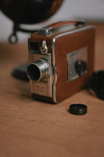 an old style camera on a table with a small hole in it