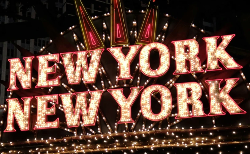 fireworks glow brightly above a new york sign