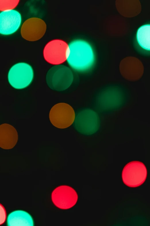 green, red, and yellow lights shining from a black background