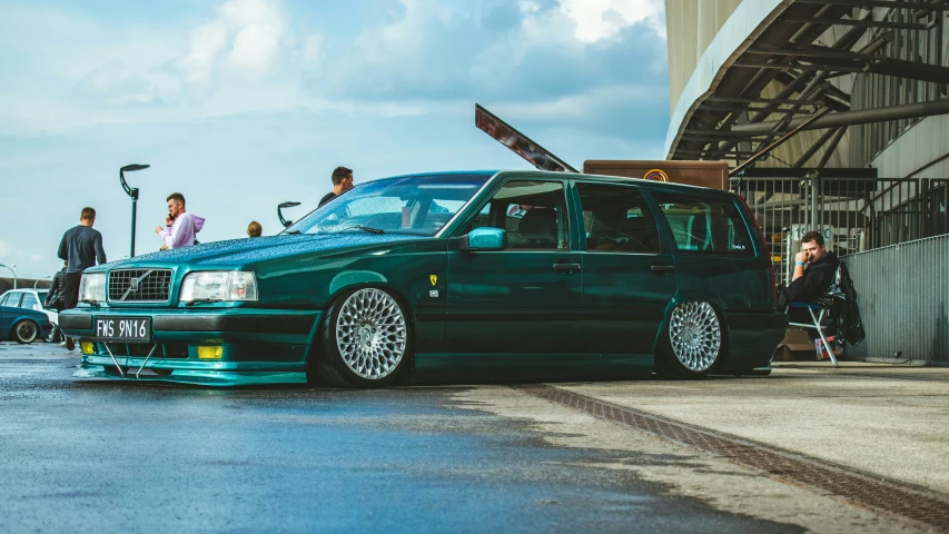 this is a green volvo wagon that looks like it has been modified
