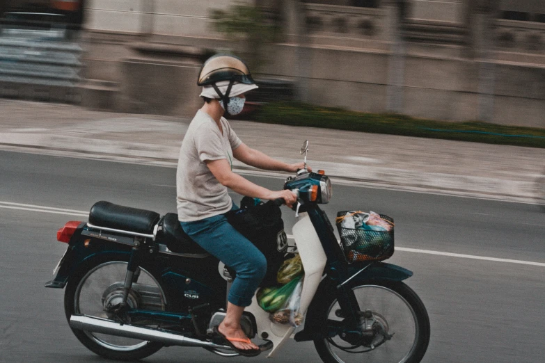 a man on a motor scooter with a helmet