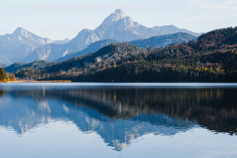 a lake surrounded by mountains that look like they have been built