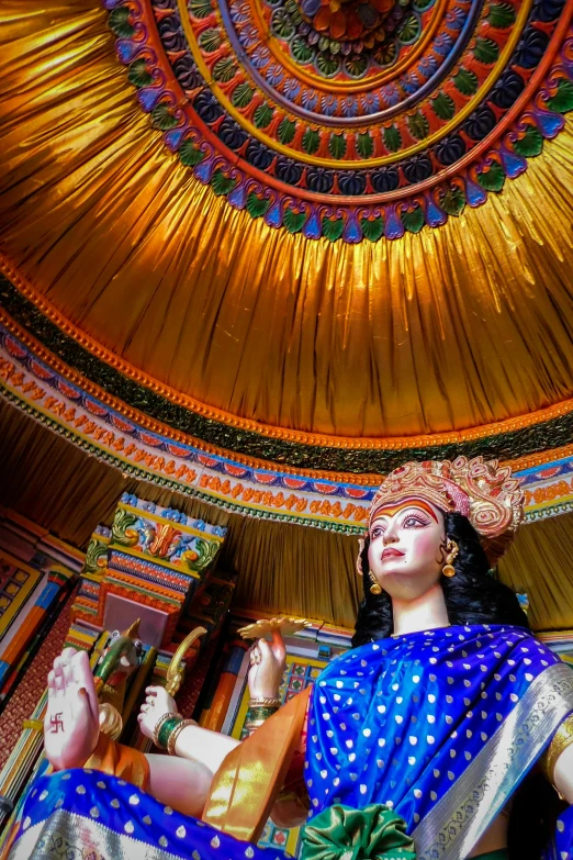 a statue of a hindu woman in a gold circle