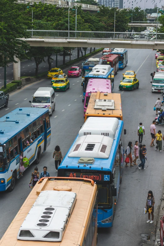 busses lined up on the side of a city street