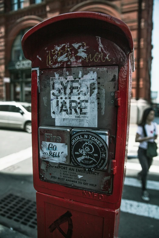 a red parking meter sitting in the middle of a street