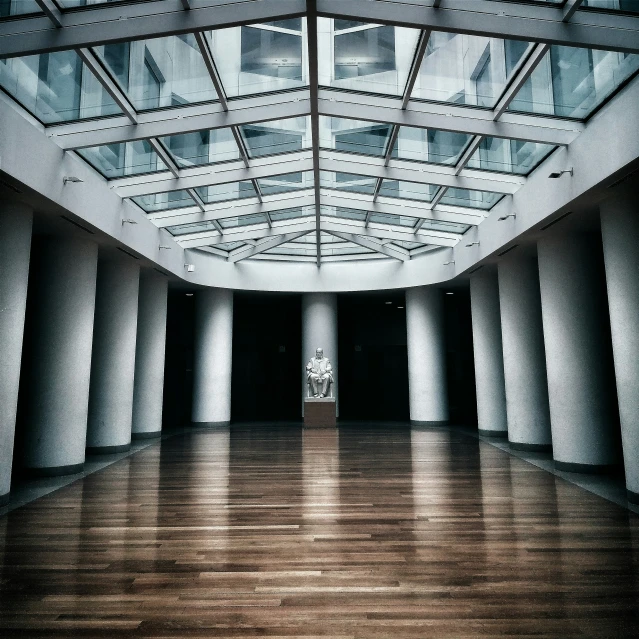 an empty building with white pillars and lights